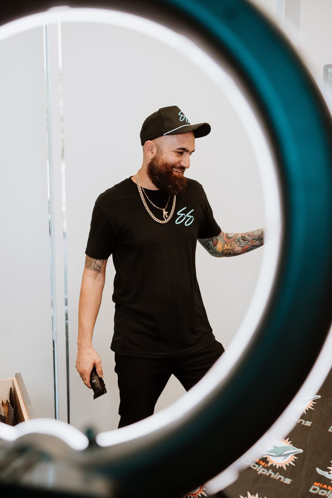 Chris Sacconi smiling in the suite, seen through the ring light